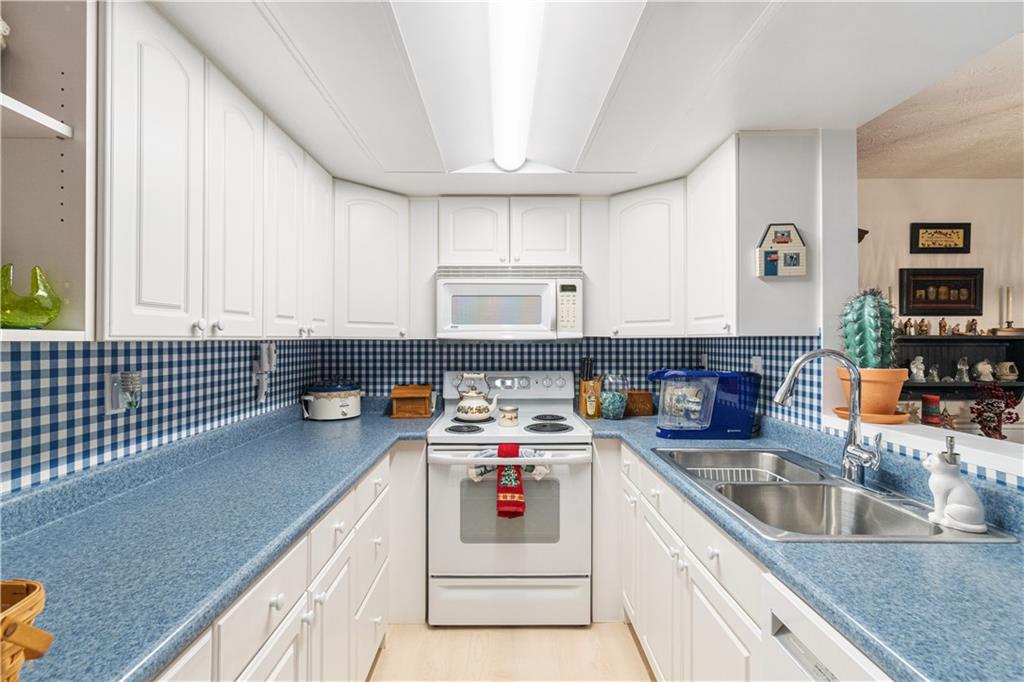 321 Ridge Point Circle, Unit 33B Bridgeville, PA 15017 - Photo 15 of 25 a kitchen that has a lot of cabinets in it and wooden floor