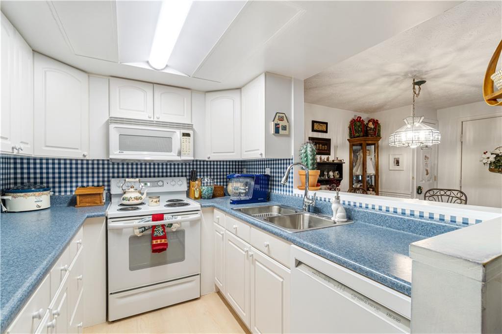 321 Ridge Point Circle, Unit 33B Bridgeville, PA 15017 - Photo 16 of 25 a kitchen that has a lot of cabinets