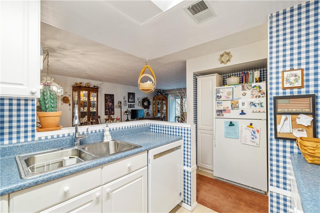 321 Ridge Point Circle, Unit 33B Bridgeville, PA 15017 - Photo 18 of 25 a kitchen with granite countertop a sink and a refrigerator