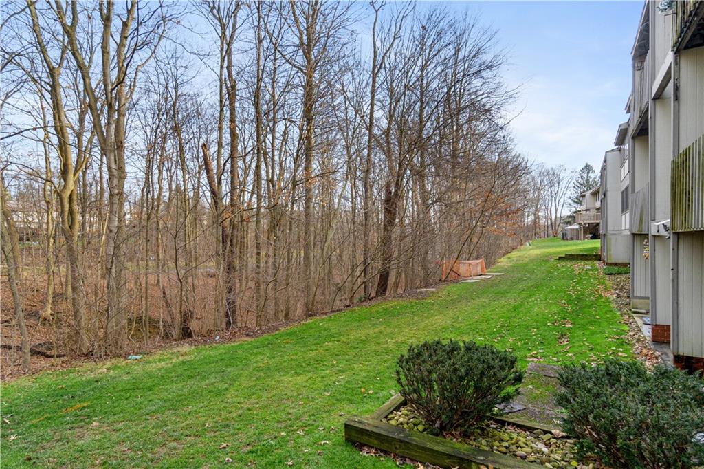 321 Ridge Point Circle, Unit 33B Bridgeville, PA 15017 - Photo 24 of 25 a view of a backyard with large trees