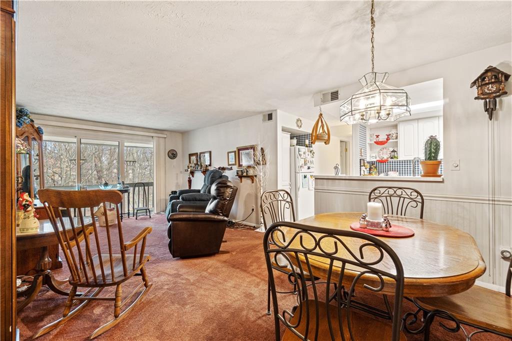 321 Ridge Point Circle, Unit 33B Bridgeville, PA 15017 - Photo 8 of 25 a dining room with furniture a chandelier and window