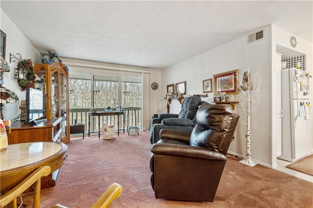 321 Ridge Point Circle, Unit 33B Bridgeville, PA 15017 - Photo 10 of 25 a living room with furniture and a floor to ceiling window