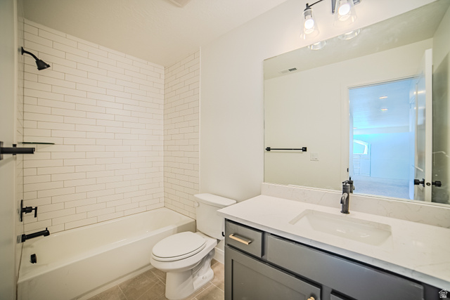 45 North Scarlet Maple Road, Unit 4317 Vineyard, UT 84059 - Photo 29 of 35 Bathroom featuring a subway tile shower surround, matte black fixtures, a white vanity countertop, and a vanity with gray cabinetry and gold-tone hardware