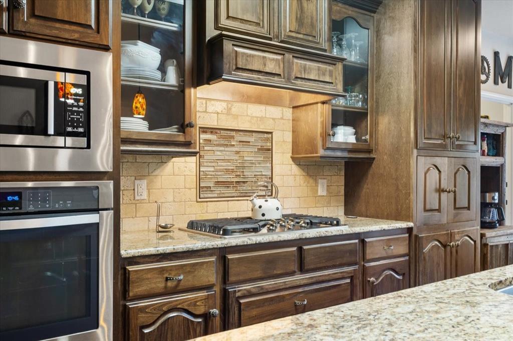 2170 Derrs Chapel Road Italy, TX 76651 - Photo 11 of 38 a kitchen with stainless steel appliances kitchen island granite countertop a stove and a sink