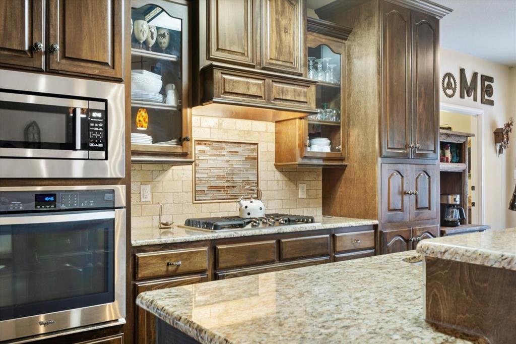 2170 Derrs Chapel Road Italy, TX 76651 - Photo 12 of 38 a kitchen with stainless steel appliances granite countertop a stove and a microwave