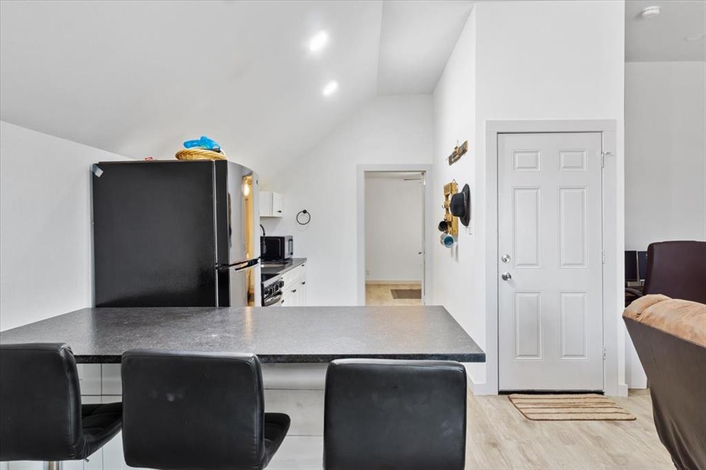 2170 Derrs Chapel Road Italy, TX 76651 - Photo 24 of 38 a kitchen with stainless steel appliances a dining table and chairs
