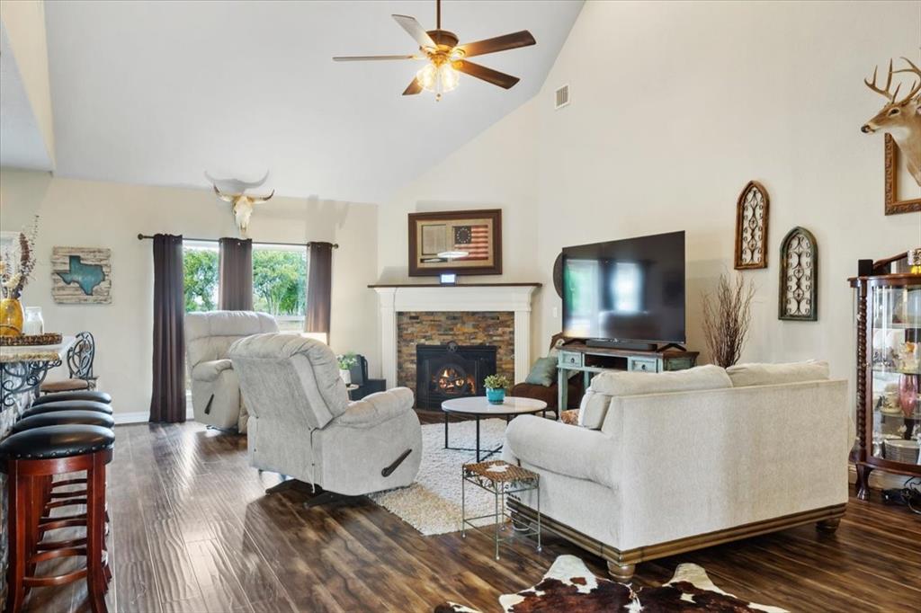 2170 Derrs Chapel Road Italy, TX 76651 - Photo 6 of 38 a living room with furniture a flat screen tv and a fireplace