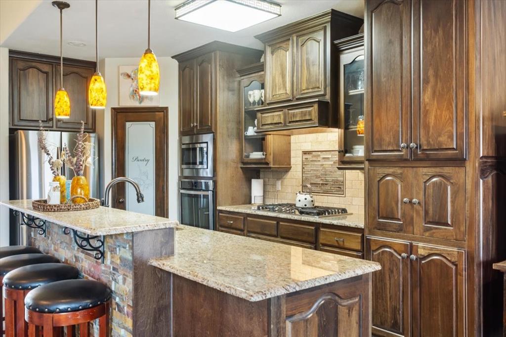 2170 Derrs Chapel Road Italy, TX 76651 - Photo 10 of 38 a kitchen with stainless steel appliances granite countertop a sink a stove and a refrigerator