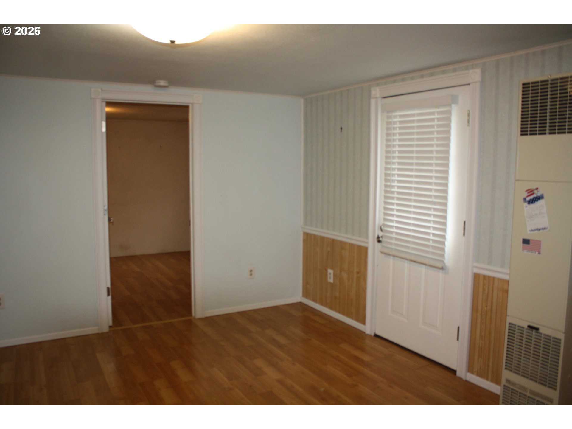 882 Northeast Rifle Range Street Roseburg, OR 97470 - Photo 13 of 16 a view of an empty room with wooden floor and a window