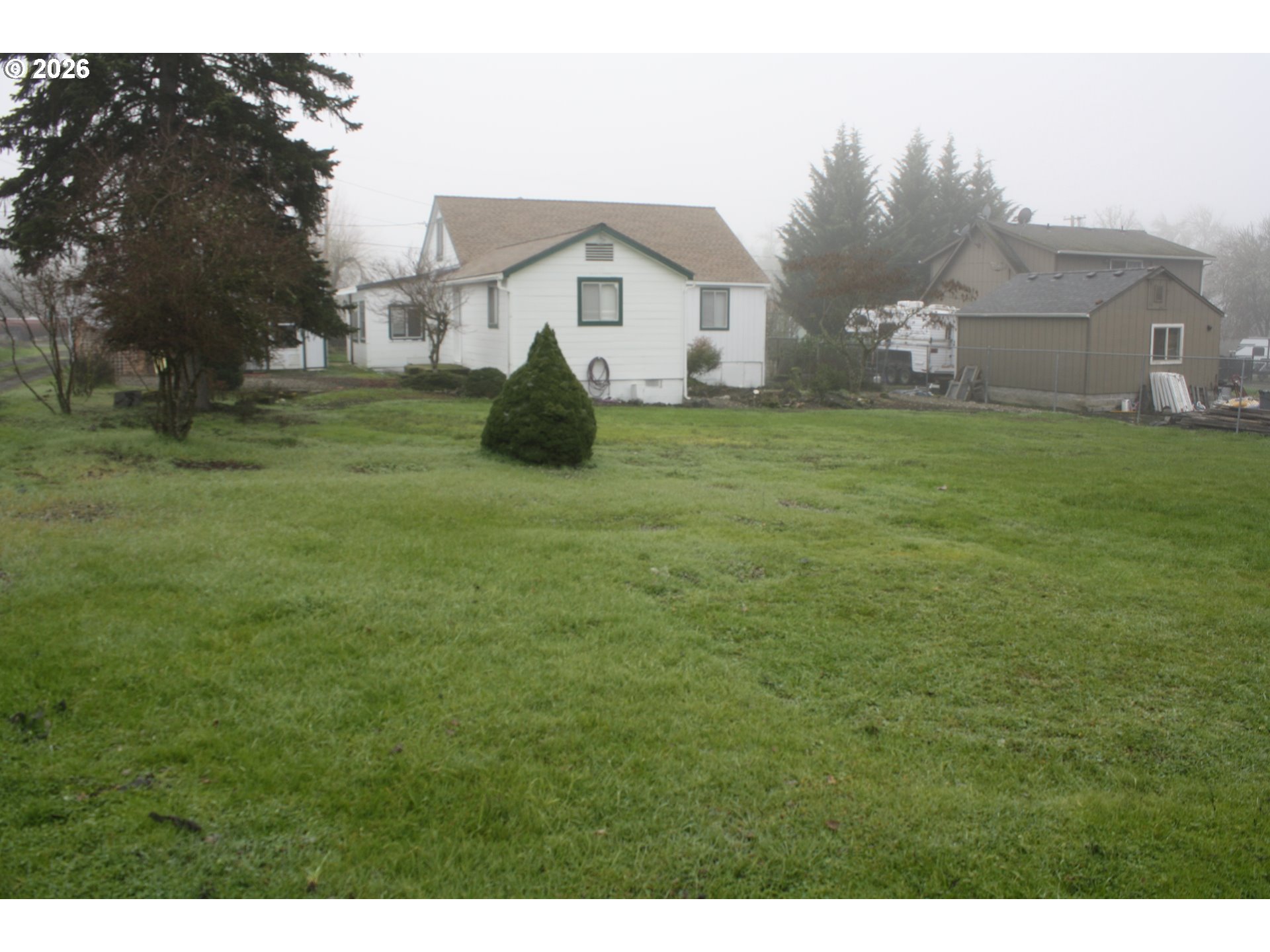 882 Northeast Rifle Range Street Roseburg, OR 97470 - Photo 14 of 16 a view of a house with a big yard and large tree