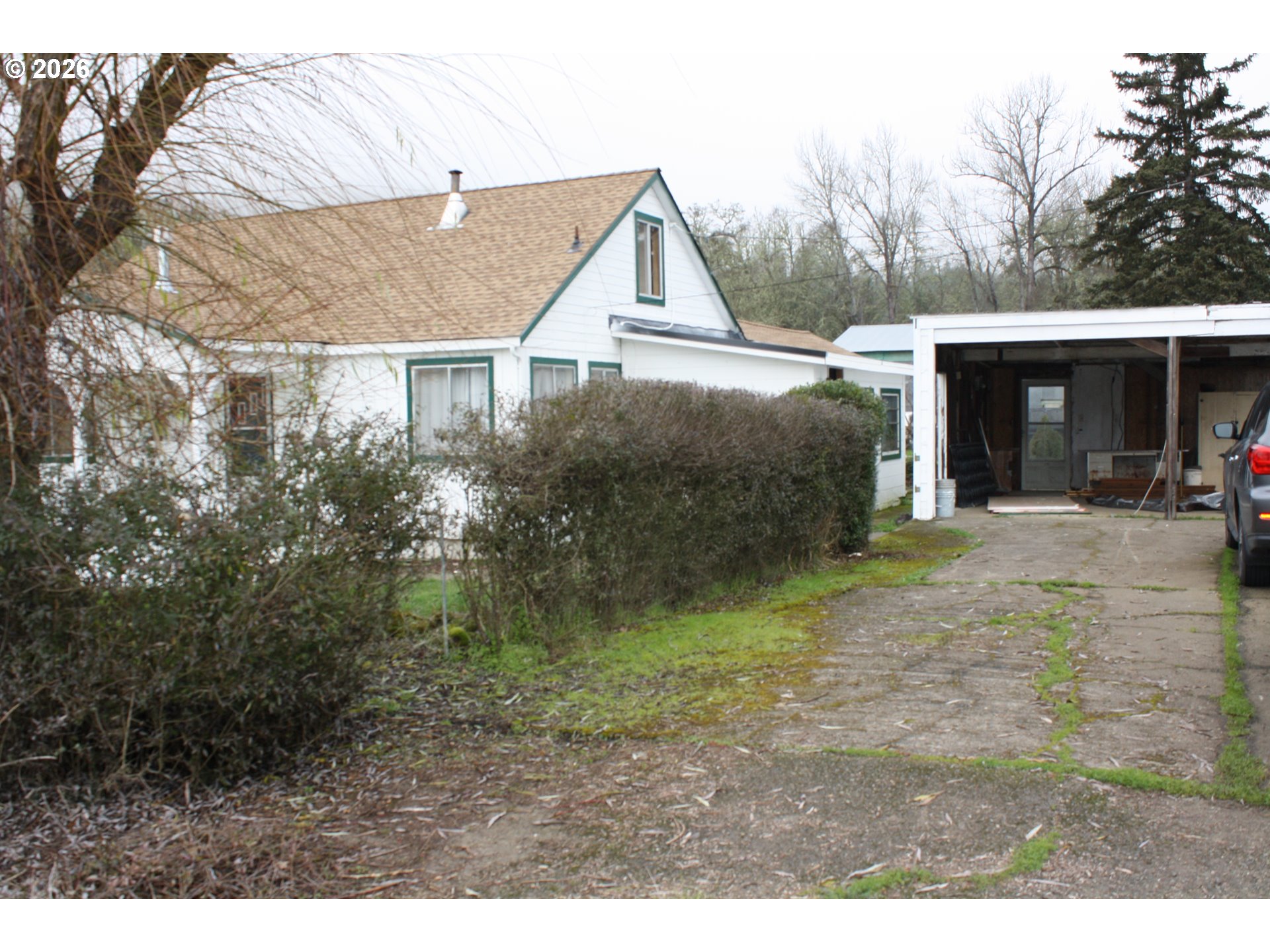 882 Northeast Rifle Range Street Roseburg, OR 97470 - Photo 3 of 16 a view of a house with backyard and trees