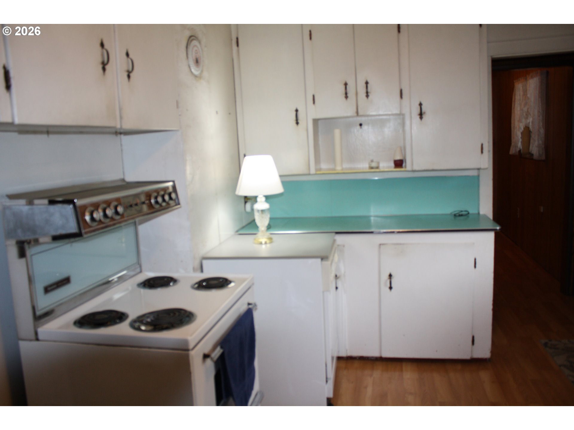 882 Northeast Rifle Range Street Roseburg, OR 97470 - Photo 10 of 16 a kitchen with a sink a stove and cabinets