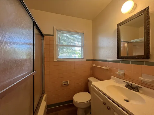 a bathroom with a sink toilet and mirror