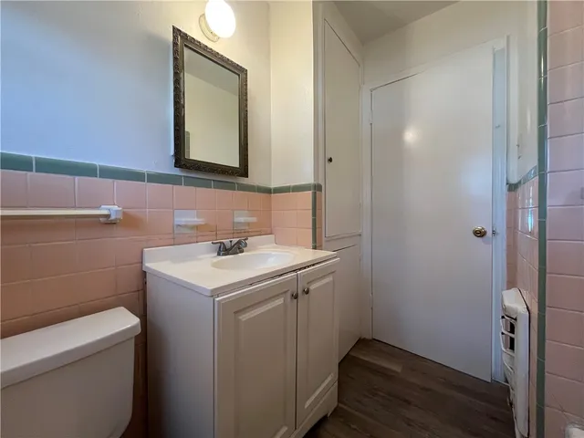 a bathroom with a sink toilet and mirror