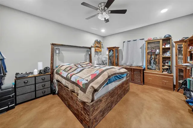 a bedroom with a bed dresser and a large mirror