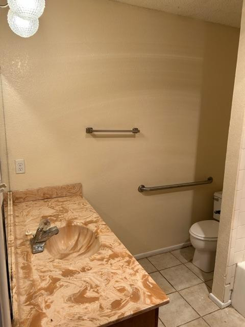 1113 80th Street, Unit B Lubbock, TX 79423 - Photo 12 of 14 a bathroom with a sink and a toilet