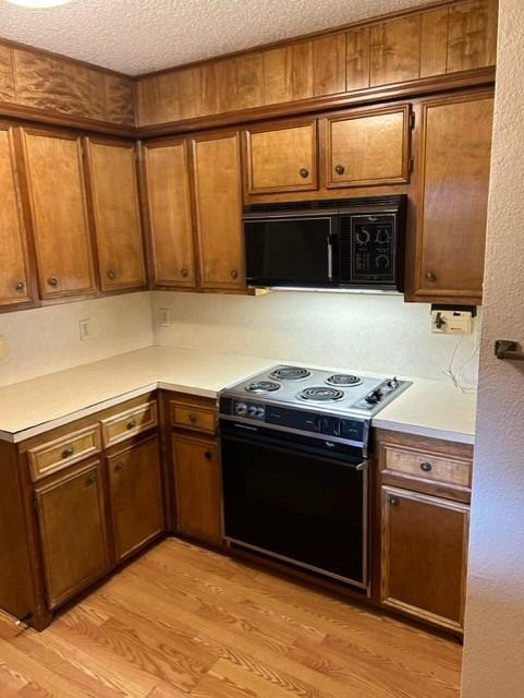 1113 80th Street, Unit B Lubbock, TX 79423 - Photo 5 of 14 a kitchen with stainless steel appliances granite countertop a stove and a sink