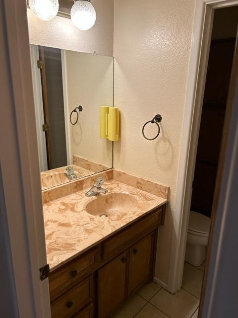 1113 80th Street, Unit B Lubbock, TX 79423 - Photo 7 of 14 a bathroom with a granite countertop sink and a mirror