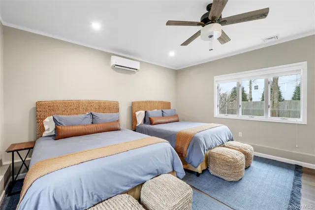 a bedroom with two beds and painting on the wall