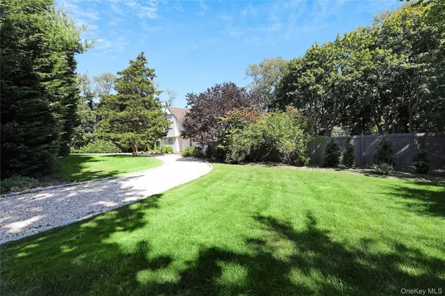 a view of a house with a yard and potted plants
