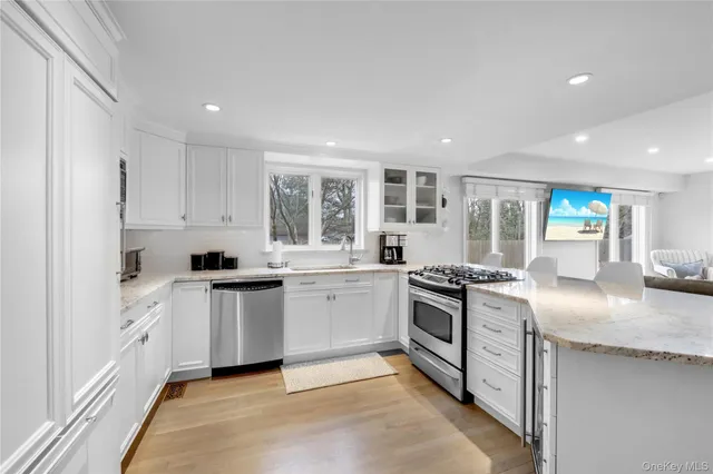 a kitchen with granite countertop white cabinets and white appliances