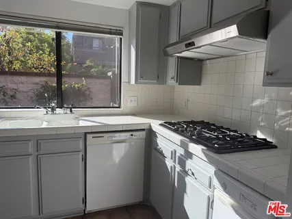 a kitchen that has a sink and a stove