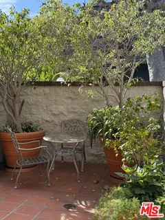 a couple of chairs and a table in a backyard