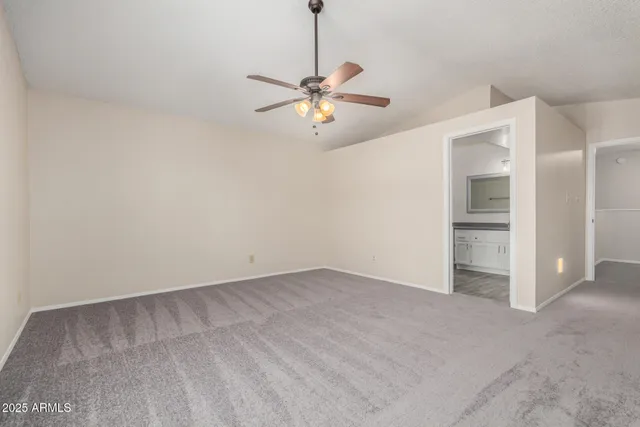 a bathroom with a granite countertop toilet sink and mirror