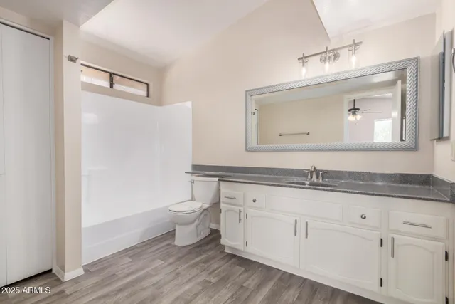 a view of room with window and ceiling fan