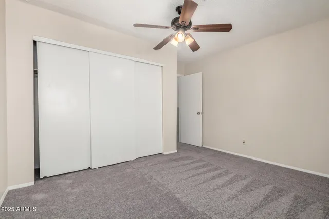 a bathroom with a granite countertop sink a toilet and shower