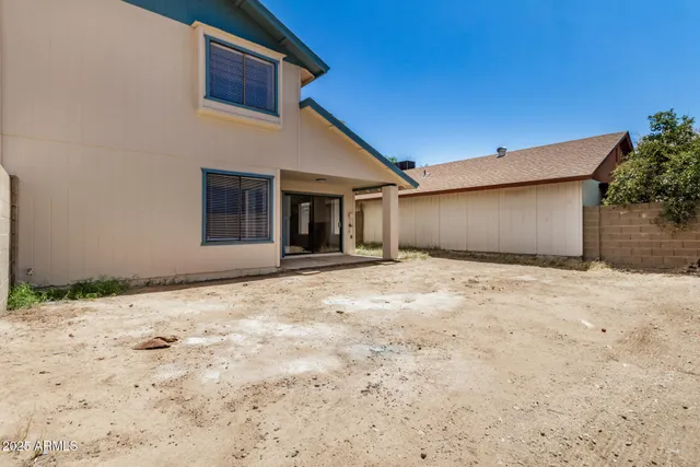 a view of a white house with a yard