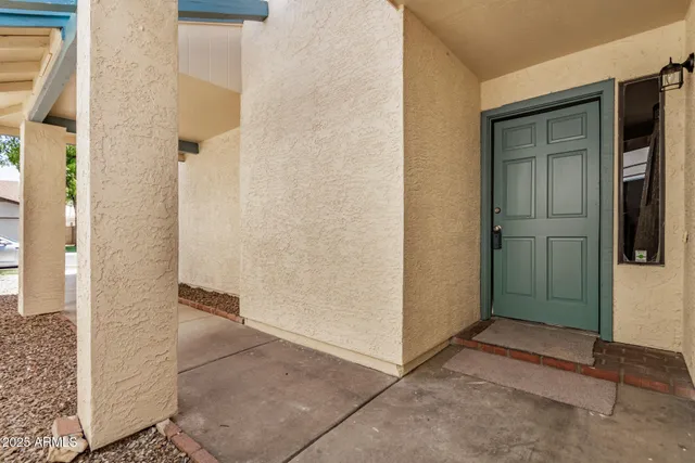 a view of a hallway with wooden floor and entryway
