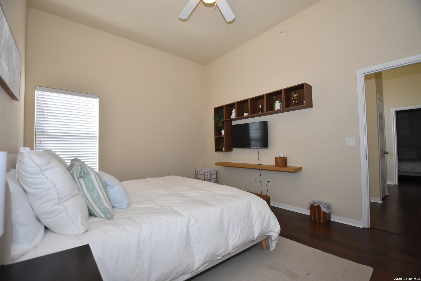 6160 Eckhert Road, Unit 804 San Antonio, TX 78240 - Photo 17 of 39 a bedroom with a bed and a flat tv screen on the dresser