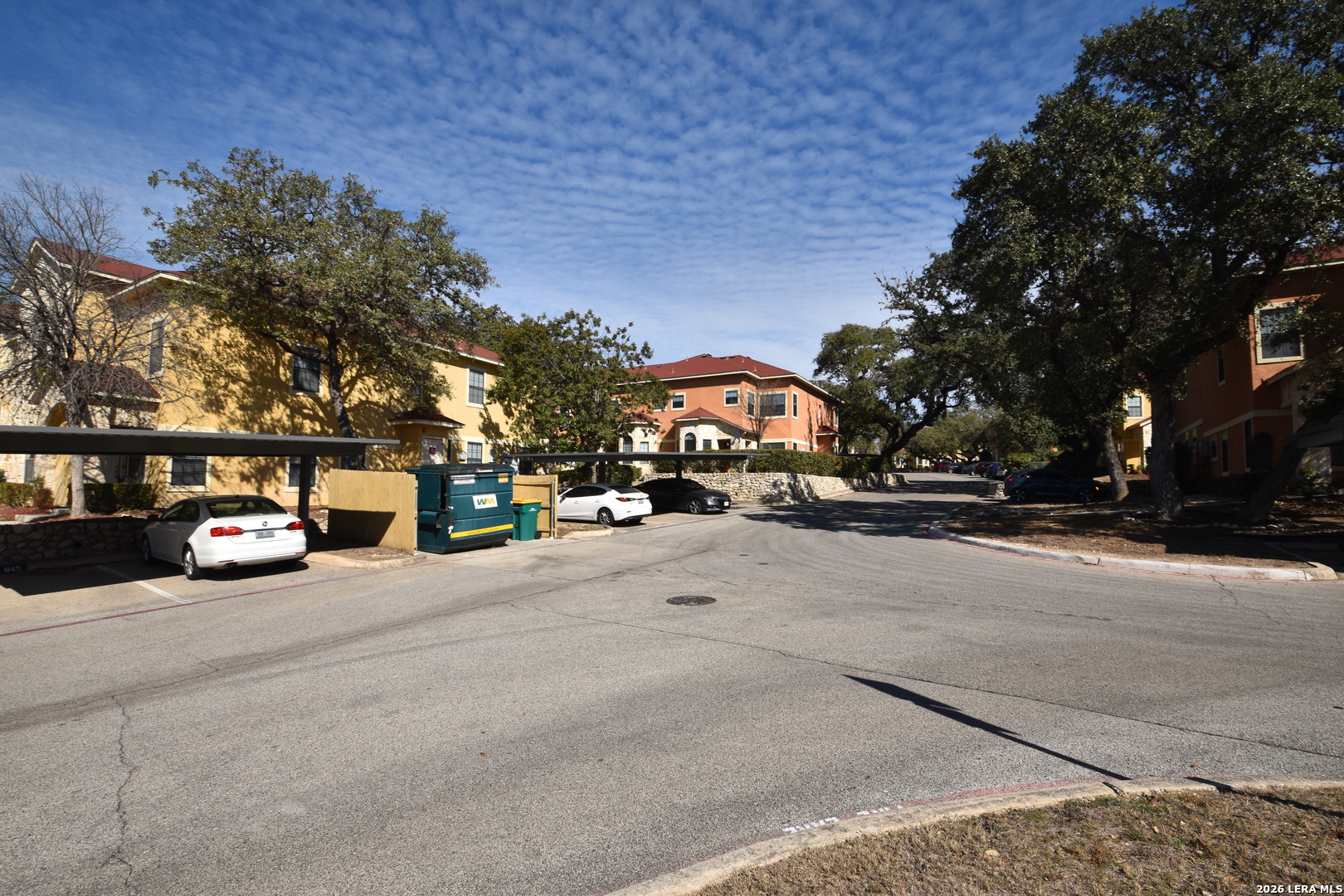 6160 Eckhert Road, Unit 804 San Antonio, TX 78240 - Photo 37 of 39 a view of road with card parked on side and retail shops