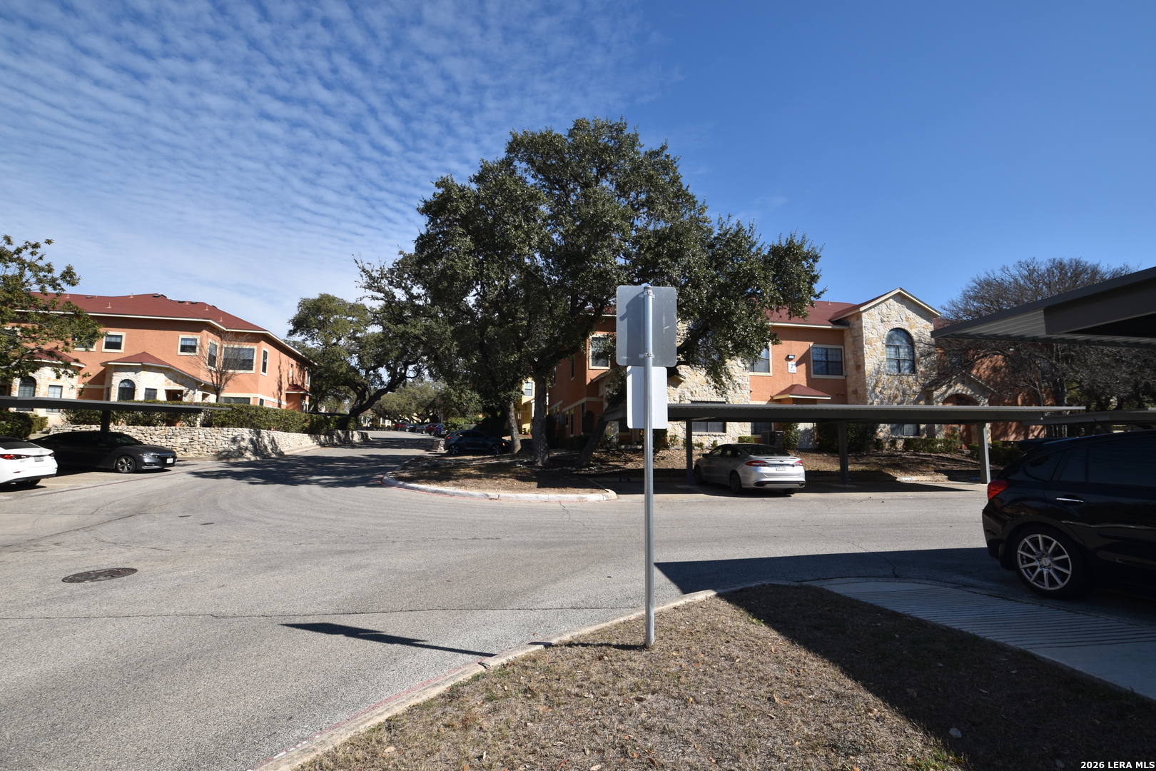 6160 Eckhert Road, Unit 804 San Antonio, TX 78240 - Photo 38 of 39 a city street lined with parked cars and buildings