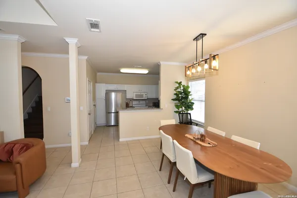 a dining room with furniture and a chandelier