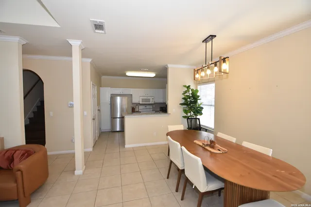 a dining room with furniture and a chandelier