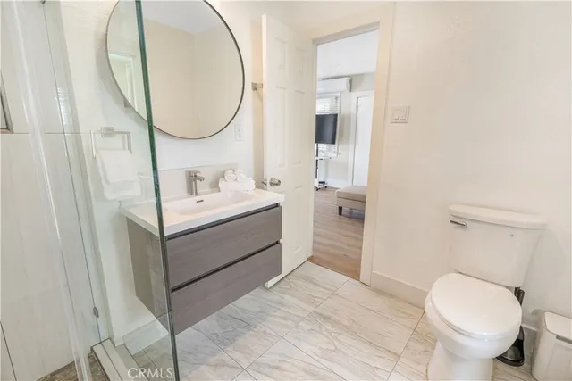 a bathroom with a sink toilet and a mirror