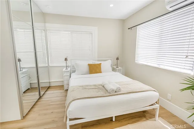 a bedroom with a bed and wooden floor