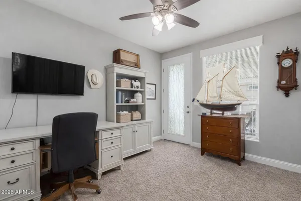 a view of a workspace with furniture and a flat screen tv