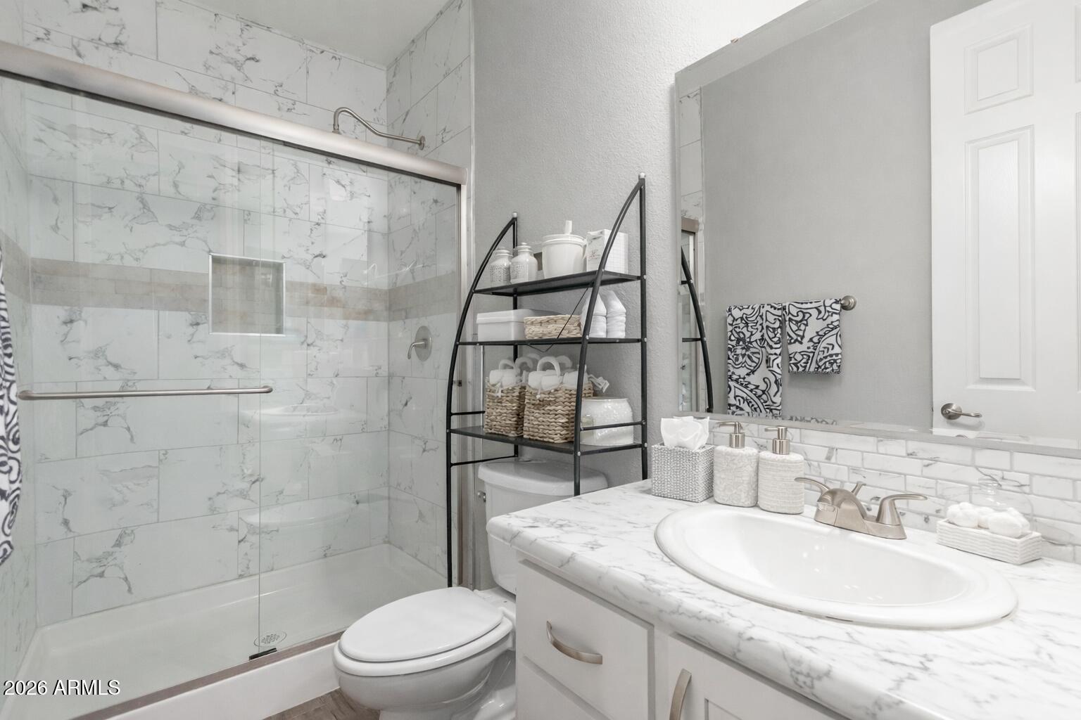 3301 South Goldfield Road, Unit 6031 Apache Junction, AZ 85119 - Photo 13 of 34 a bathroom with a sink a toilet and shower