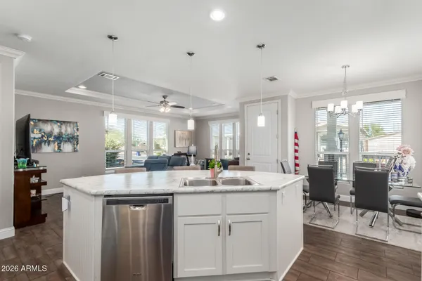 a kitchen with sink stove and wooden floor