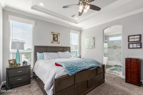 a bedroom with a bed and a chandelier