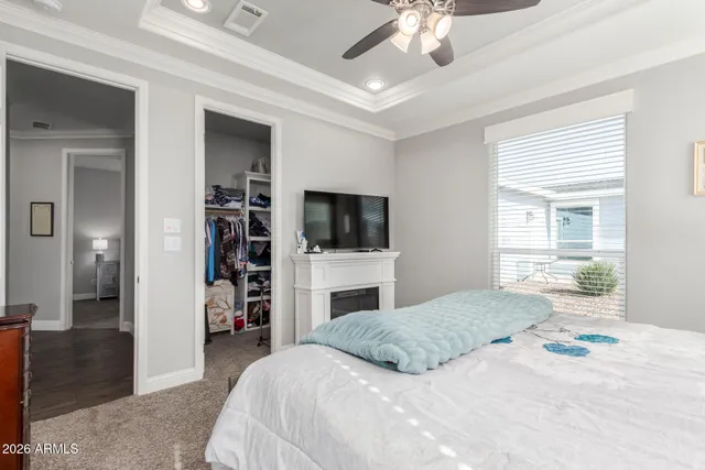 a room with lots of tables a mirror and a fan