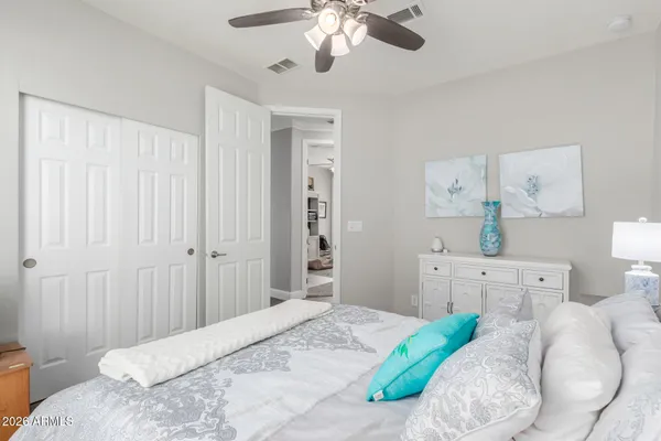 a bedroom with a bed and a chandelier