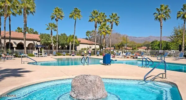 a view of a swimming pool with a table and chairs