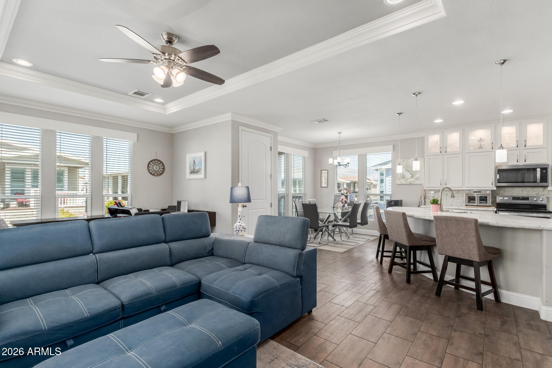 3301 South Goldfield Road, Unit 6031 Apache Junction, AZ 85119 - Photo 6 of 34 a living room with furniture kitchen view and a chandelier