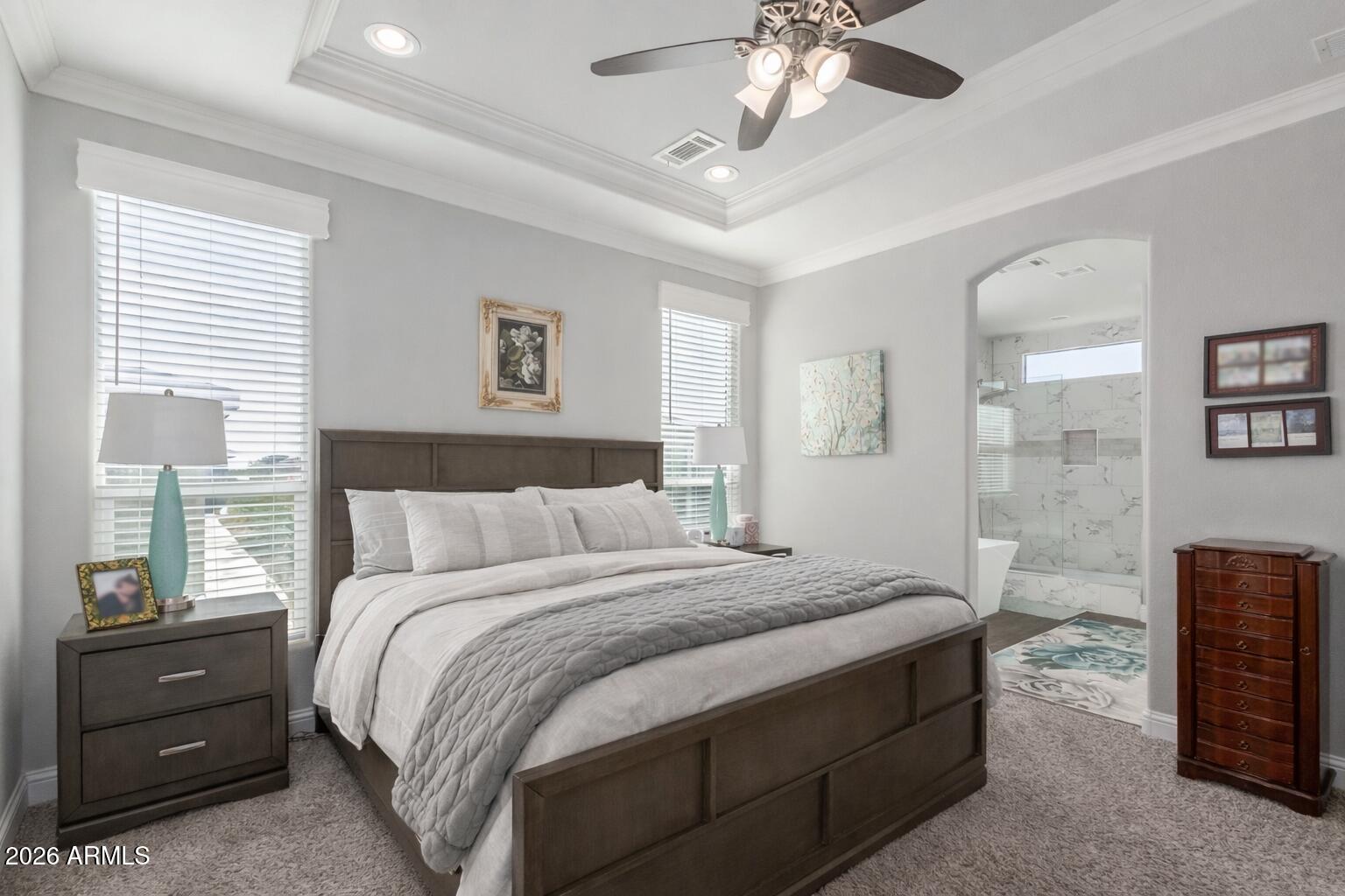 3301 South Goldfield Road, Unit 6031 Apache Junction, AZ 85119 - Photo 7 of 34 a bedroom with a bed and a chandelier