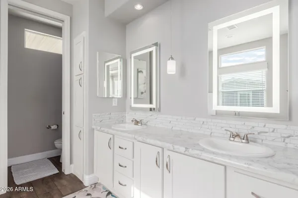 a bathroom with double sink and a mirror