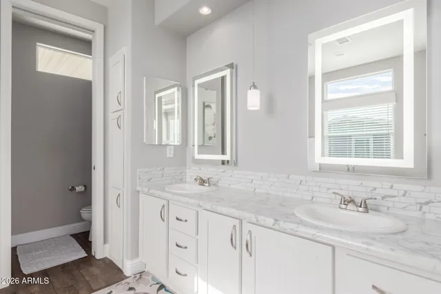 a view of a workspace with furniture and a flat screen tv